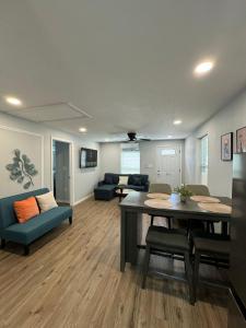 a living room with a table and chairs and a couch at Lovely unit central location in St. Petersburg