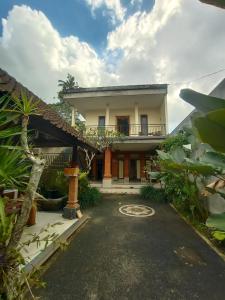 a large house with a driveway in front of it at Gusti family guest house in Tegalalang