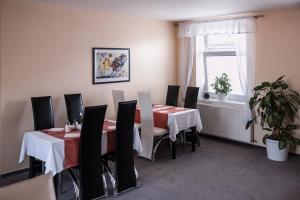 a dining room with tables and chairs and a window at Hotel Omega Brno in Brno