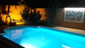 a swimming pool with blue lighting in a backyard at night at Villa Salvatore in San Leone