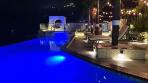 a swimming pool with blue lights in the night at The Panoramic Getaway in Munnar