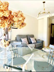 a living room with a couch and a glass table at Betalia in Caldas de Reis