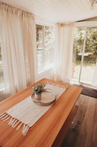 a wooden table with a vase on top of it at Bay View Casita in Olympia
