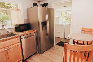 a kitchen with a stainless steel refrigerator and a table at Bay View Casita in Olympia +22 photos