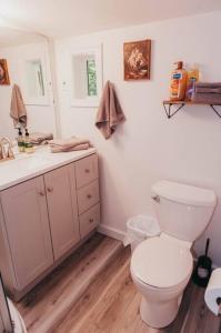 a bathroom with a white toilet and a sink at Bay View Casita in Olympia