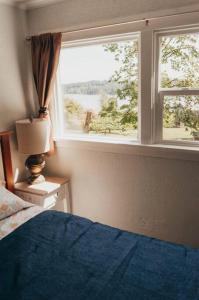 a bedroom with a bed and a window at Bay View Casita in Olympia