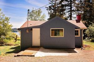 a small gray house with a white garage at Bay View Casita in Olympia