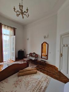 a living room with a bed and a mirror at Champollion Palace in Cairo