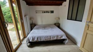 a bedroom with a bed in a room with a window at Chalet in Bazoches-sur-le-Betz
