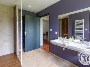 a bathroom with two sinks and a large mirror at Gîte paisible au cœur des vignobles avec jardin et parking privatif - FR-1-622-3 in Rochefort-sur-Loire +16 photos
