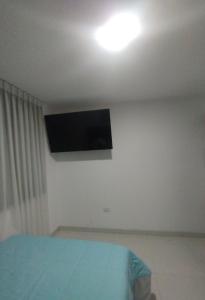 a bedroom with a flat screen tv on the ceiling at ALPHA69 in Cajamarca