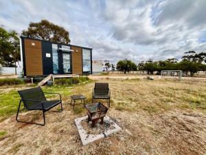 a tiny house with two chairs and a table at Avondale Heights 