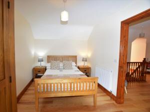 a bedroom with a bed and two tables and a mirror at 3 Bed in New Quay LLWYD in Pencader