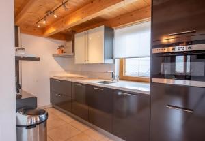 a kitchen with stainless steel appliances and a window at Almhäuser Filzsteinalpe Almhaus 198 in Krimml