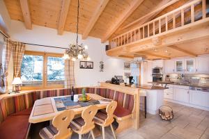 a kitchen with a table and chairs in a room at Chalet Christallo 180 Chalet Christallo in Krimml