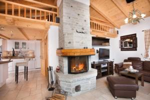 a living room with a fireplace in a house at Chalet Christallo 180 Chalet Christallo in Krimml