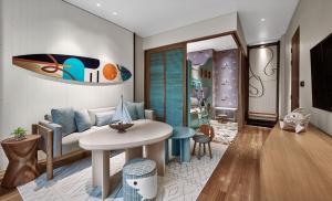 a living room with a couch and a table at Holiday Inn Resort Bali Canggu by IHG in Canggu