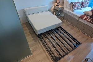 a room with a bench in the middle of a bed at Cosy City Studio Apartment in Melbourne