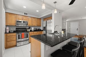 a kitchen with wooden cabinets and a black counter top at 1 Bedroom Unit in Hyde Park House in Tampa