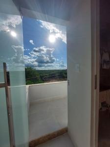 a room with a window with a view at Pousada Luz do Sol in Piranhas