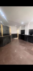 a empty room with black furniture and a tile floor at City Palace in Sao Paulo