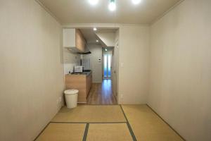 an empty room with a kitchen and a hallway at 【SHO-HOUSE】駅から徒歩3分 in Osaka +27 photos