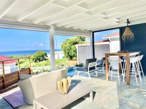 a living room with a view of the ocean at Galanterie in Grand-Bourg
