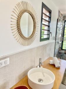 a bathroom with a sink and a mirror at Galanterie in Grand-Bourg