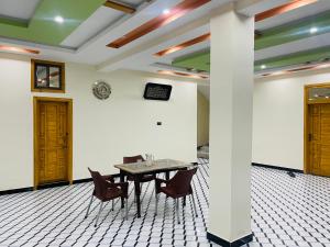 a dining room with a table and chairs at The Abbott Crown Hotel Rajwal in Kāgān +25 photos
