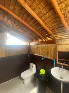 a bathroom with a toilet and a sink at Lily's Beach Bungalows in Koh Rong Island