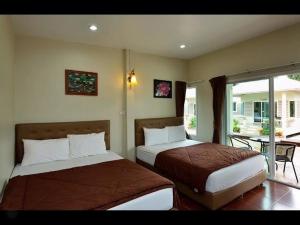 Llit o llits en una habitació de Pleai Ta Lea Resort