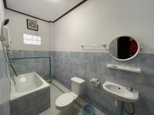 a bathroom with a toilet and a sink and a mirror at Nakai Resort in Ban Nakay Nua