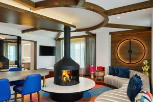 a fireplace in a living room with a couch and a table at W Aspen in Aspen