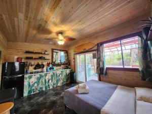 1 dormitorio con 1 cama y cocina en cabin 6 new cottage with private hot tub, en Fern Forest