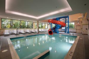 a swimming pool with a slide in a building at Fairfield Inn & Suites by Marriott Edmonton North in Edmonton