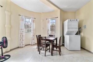a kitchen with a table and chairs and a refrigerator at Kaibus Place K3 2/bedroom in Morne Rouge