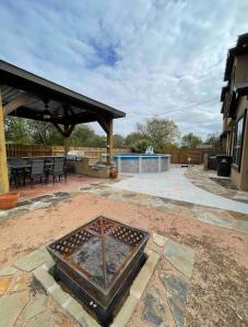 an outdoor patio with a grill and a pavilion at Spacious Austin Home in Austin