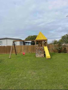 a playground with a slide and a play structure at Spacious Austin Home in Austin