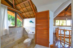 uma casa de banho com um WC, um lavatório e janelas em Tropicana Ocean Villas em Boracay