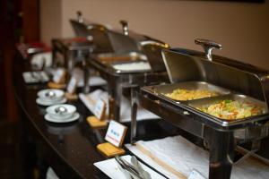 a buffet line with dishes of food in trays at Sapa Highland Resort & Spa in Sa Pa