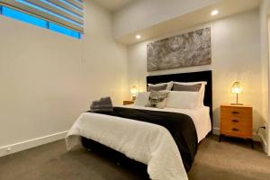 a bedroom with a large bed and a window at The Statesman in Hamilton