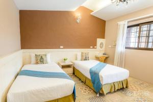 Postel nebo postele na pokoji v ubytování Hai Yuan Bungalow II