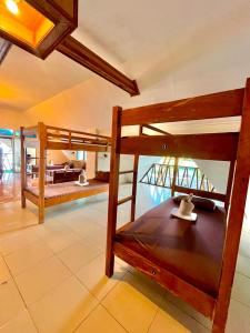 a room with two bunk beds and a bedroom at On Board Panglao Beach Hostel & Resort in Dao