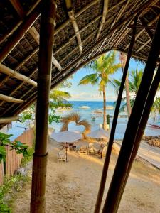 a view of a beach with umbrellas and the ocean at On Board Panglao Beach Hostel & Resort in Dao