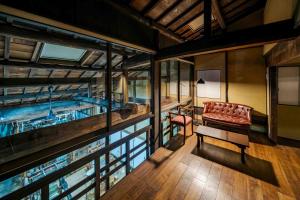 a room with a pool with a couch and a table at Nishijin Isa Machiya Holiday House in Nishijin