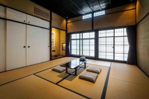 a living room with a table and a large window at Nishijin Isa Machiya Holiday House in Nishijin +46 photos