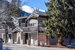 a large house with a snow covered mountain at Cross Creek - Pool and Hot Tubs by Daniel in Frisco