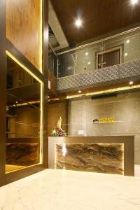 a lobby with a fireplace in a building at Mumbai House Luxury Apartments Santacruz East, Mumbai in Mumbai
