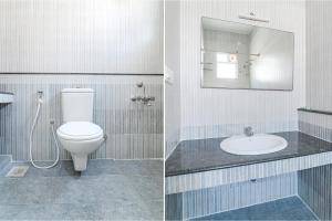 a bathroom with a toilet and a sink and a mirror at FabHotel VRJ Residency in Chennai