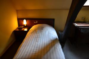 Postel nebo postele na pokoji v ubytování Hotel De Franse Kroon